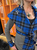 Stricking wrap jacket with blue tartan collar and vegan leather trim and belt, large safety pin brocher