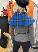 Stricking wrap jacket with blue tartan collar and vegan leather trim and belt, large safety pin brocher