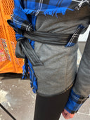 Stricking wrap jacket with blue tartan collar and vegan leather trim and belt, large safety pin brocher